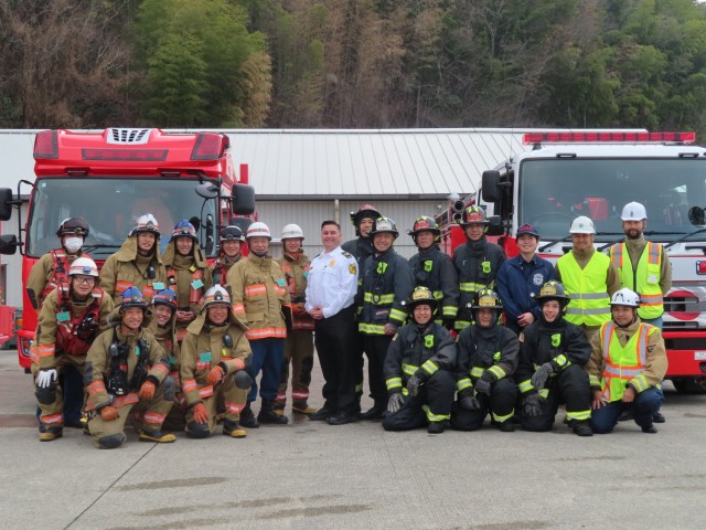 Firefighters from U.S. Army Garrison Japan, right, and the Kure Fire Department pose for a photo following a joint training exercise at Hiro Ammunition Depot, Japan, Feb. 13, 2024. Garrison firefighters have recently stepped up their efforts to...