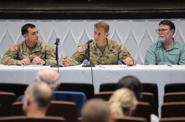 Col. Marcus Hunter, center, commander of U.S. Army Garrison Japan, Command Sgt. Maj. David A. Rio, left, garrison senior enlisted leader, and Perry Cannon, chief of the Housing Office’s Housing Operations Branch, participate in a housing town...