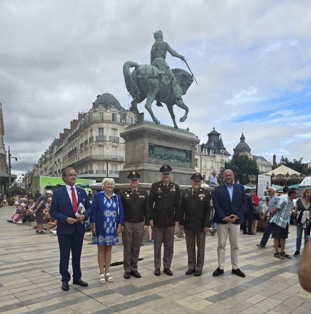 The 35th Infantry Division commander Maj. Gen. John Rueger, Command Sgt. Maj. Rob Istas, and Aide-de Camp Maj. Dustin Dice, along with several Orleans city officials, pose with a statue of Joan of Arc in Orleans, France August 16. The command team...