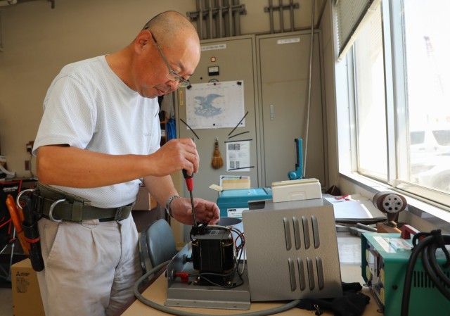 Shinroku Ishida, an electrician for the Directorate of Public Works, fixes a power converter at the Akizuki Ammunition Depot in Japan, Sept. 5, 2024. The DPW workforce handles various skilled trade and office jobs to support tenant organizations,...