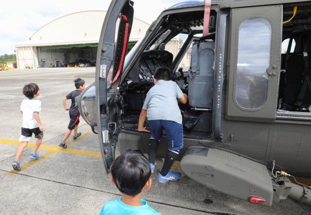 Residents from the Central Children’s Home check out a UH-60 Black Hawk helicopter at Camp Zama, Japan, Sept. 23, 2024. The children toured the helicopter as part of their visit to the installation that also included playing dodgeball with...