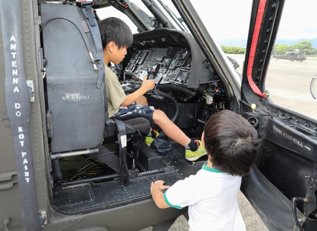 Residents from the Central Children’s Home check out a UH-60 Black Hawk helicopter at Camp Zama, Japan, Sept. 23, 2024. The children toured the helicopter as part of their visit to the installation that also included playing dodgeball with...