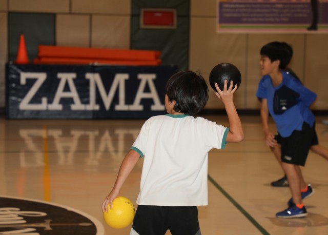 Residents from the Central Children’s Home play dodgeball with Soldiers inside the Youth Center at Camp Zama, Japan, Sept. 23, 2024. The children also toured a UH-60 Black Hawk helicopter as part of their visit to the installation.