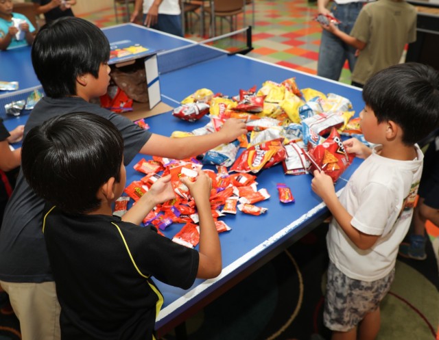 Residents from the Central Children’s Home take a snack break after playing dodgeball with Soldiers inside the Youth Center at Camp Zama, Japan, Sept. 23, 2024. The children also toured a UH-60 Black Hawk helicopter as part of their visit to the...