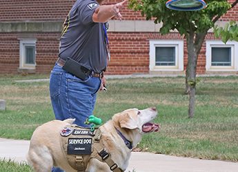 Jackson, a service dog, stays by Veteran’s side