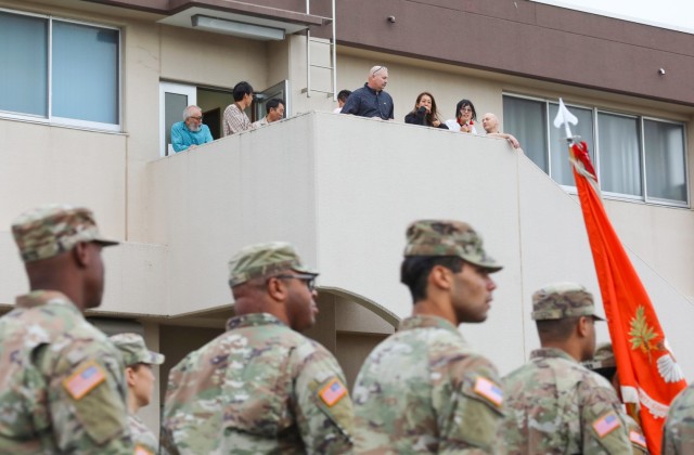 Employees watch a group of Soldiers march during a homecoming parade at Camp Zama, Japan, Oct. 10, 2024. Several U.S. Army Garrison Japan personnel helped with the parade and a bonfire that night in support of Zama Middle High School students.