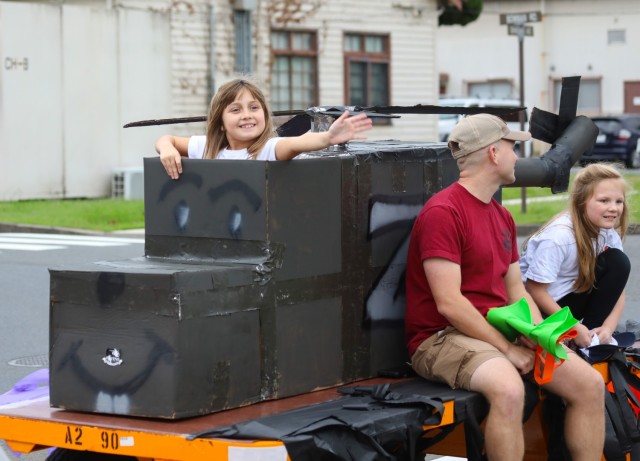 Community members participate in a homecoming parade at Camp Zama, Japan, Oct. 10, 2024. Several U.S. Army Garrison Japan personnel helped with the parade and a bonfire that night in support of Zama Middle High School students.