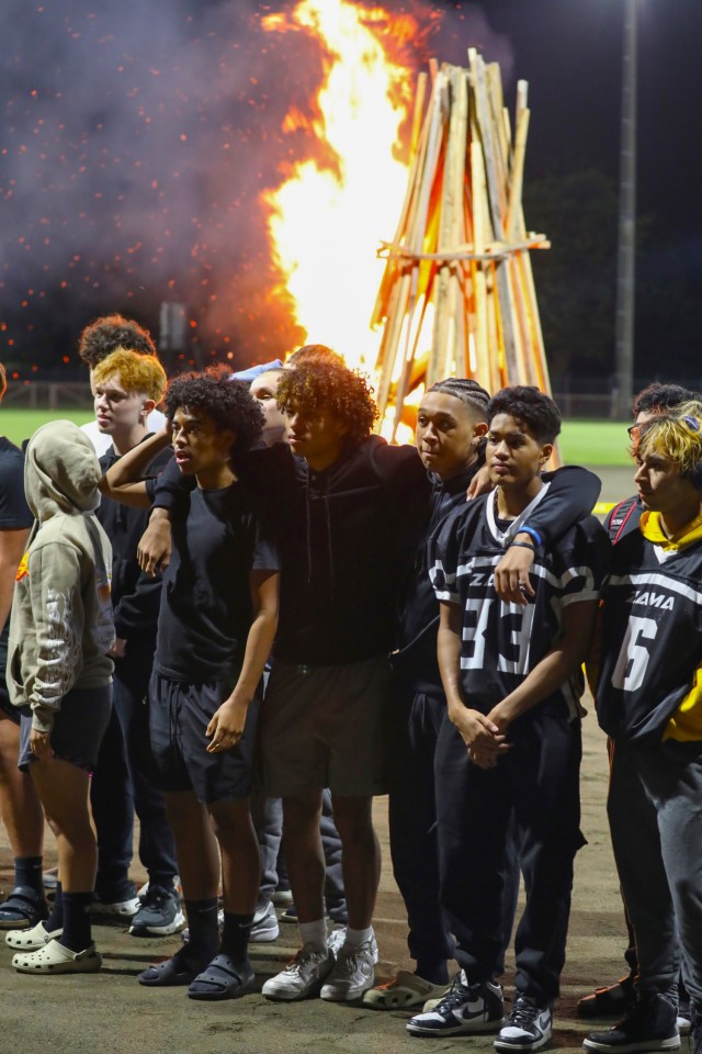 Zama Middle High School students stand in front a bonfire as part of the school's homecoming activities at Camp Zama, Japan, Oct. 10, 2024. U.S. Army Garrison Japan personnel helped support the bonfire and a parade earlier that day.