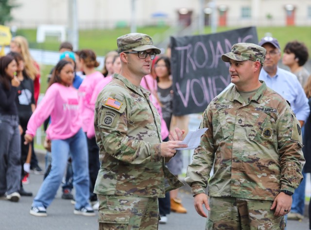 Maj. Michael Clark, left, operations officer, and Sgt. 1st Class Jimmie Gilchrist, operations sergeant, both assigned to the Directorate of Plans, Training, Mobilization and Security, conduct final checks before the start of a homecoming parade at...