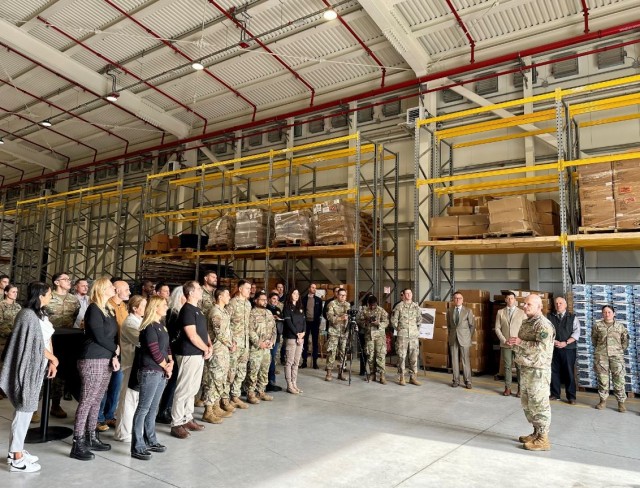 Soldiers, Airmen, U.S. and Italian civilian employees listen as U.S. Army Gen. Christopher Cavoli, commander, U.S. European Command & Supreme Allied Commander explains the importance of the new warehouse during an Oct. 9 event at Aviano Air Base.