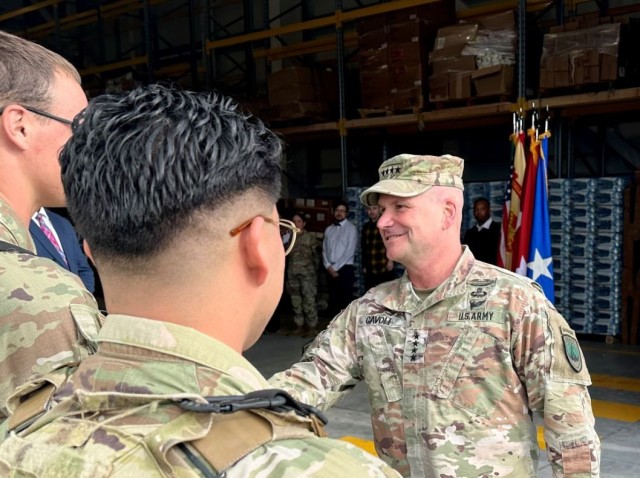 U.S. Army Gen. Christopher Cavoli, commander, U.S. European Command & Supreme Allied Commander, meet with U.S. Air Force personnel at the Oct. 9 warehouse opening at Aviano Air Base.