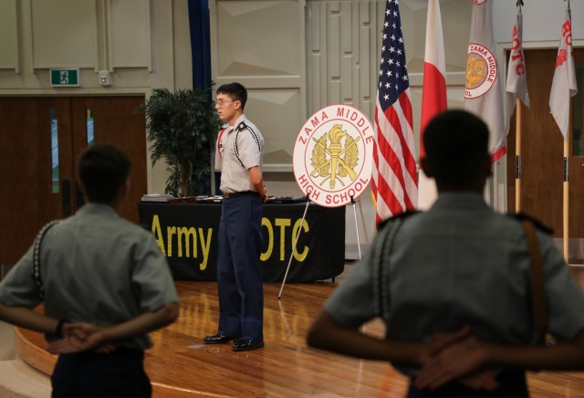 Cadet Zachary Carlile, center, the Trojan Battalion commander, addresses fellow cadets at the start of a Junior Reserve Officers’ Training Corps recognition ceremony at Camp Zama, Japan, Oct. 17, 2024. About 40 cadets were honored with awards...