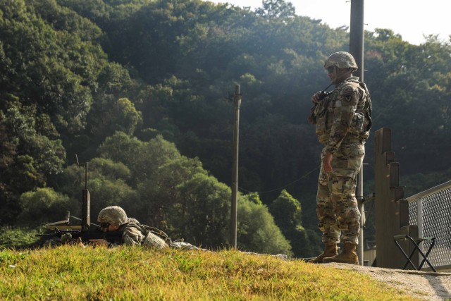 U.S. Army Staff Sgt. Victor Perez, assigned to Headquarters and Headquarters Company Yongsan-Casey, serves as safety for a Korea Augementation to the United States service member during M4 qualification at Camp Casey, Oct. 17, 2024. The safety...