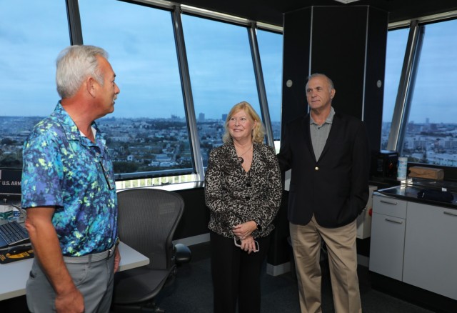 Loyd Black II, left, chief of the air traffic control tower at Kastner Airfield, briefs Trudy Floyd and her husband, Ron Cox, as they tour Camp Zama, Japan, Oct. 25, 2024. Floyd, who was born on Camp Zama in 1959, visited the installation to...