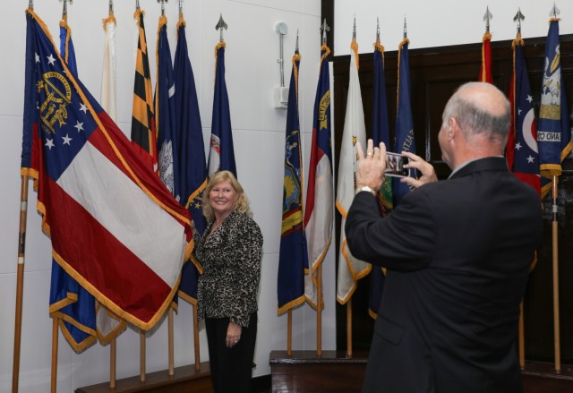 Trudy Floyd, who was born on Camp Zama in 1959, takes a photo with the Georgia state flag while touring Kizuna Hall at Camp Zama, Japan, Oct. 25, 2024. U.S. Army Garrison Japan organized a tour for Floyd, who now lives in Georgia, because she...