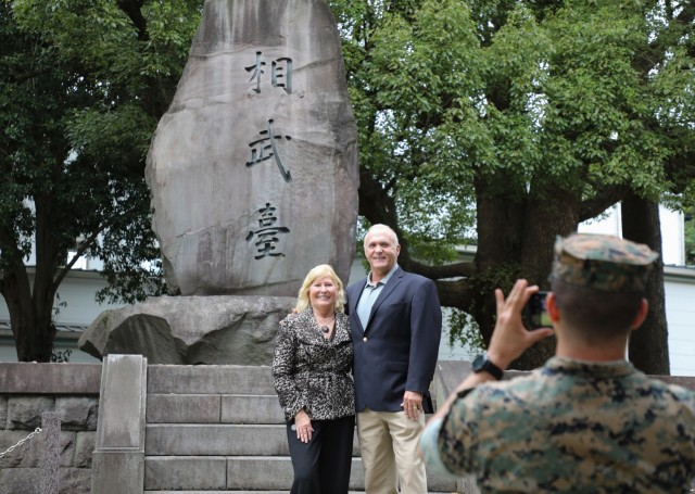 Trudy Floyd, who was born on Camp Zama in 1959, and her husband, Ron Cox, poses for a photo in front of a historical monument at Camp Zama, Japan, Oct. 25, 2024. U.S. Army Garrison Japan organized a tour for Floyd, who wanted to reconnect with her...