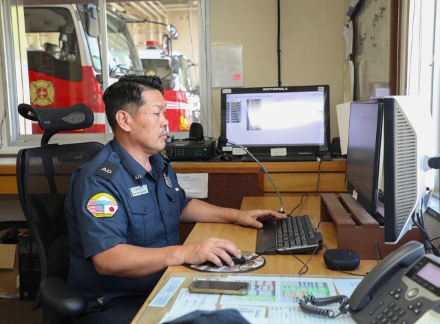 Eishin Marumoto, a U.S. Army Garrison Japan fire alarm dispatcher, works at his desk inside the Akizuki Ammunition Depot fire station in Japan Sept. 5, 2024.