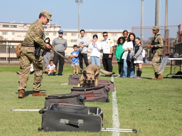 Soldiers assigned to the 901st Military Police Detachment provide a military working dog demonstration to parents and their children during the "Bring Your Kids to Work Day" event at Camp Zama, Japan, Nov. 4, 2024. Dozens of children...