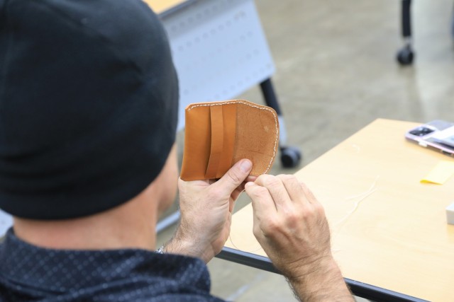 U.S. Army Staff Sgt. Douglas Smith, assigned to U.S. Army Garrison Yongsan-Casey, saddle-stitches a leather wallet during a Newcomers Cultural Awareness and Immersion Tour hosted by Dongducheon city, Bosan-dong Community Center, Bosan-dong, South...