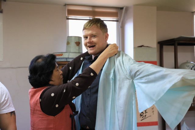 U.S. Army Staff Sgt. Jameson Harris, assigned to U.S. Army Garrison Yongsan-Casey, dons a hanbok during a Newcomers Cultural Awareness and Immersion Tour hosted by Dongducheon city, South Korea, Dec. 13, 2024. The tour included a trip to General...