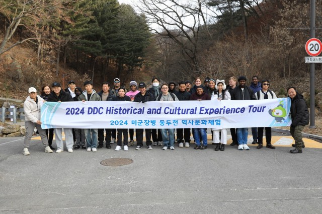 A group of 28 U.S. Soldiers, KATUSAs, and civilians assigned to U.S. Army Garrison Yongsan-Casey and 210th Field Artillery Brigade take a commemorative photograph at a natural recreation forest during a Newcomers Cultural Awareness and Immersion...