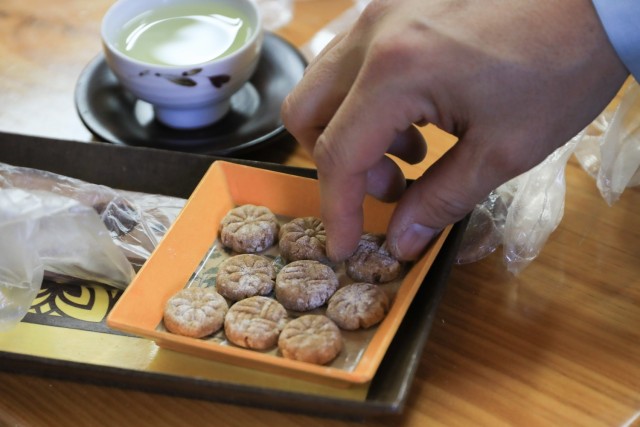 A U.S. Soldier grabs a dasik, a traditional Korean pressed dessert made from finely ground grains and honey, during a Newcomers Cultural Awareness and Immersion Tour hosted by Dongducheon city, South Korea, Dec. 13, 2024. The tour included a trip...
