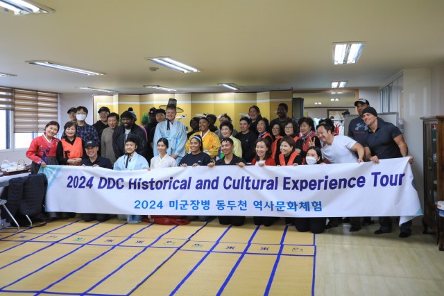 A group of 28 U.S. Soldiers, KATUSAs, and civilians assigned to U.S. Army Garrison Yongsan-Casey and 210th Field Artillery Brigade take a commemorative photograph with volunteers during a Newcomers Cultural Awareness and Immersion Tour hosted by...