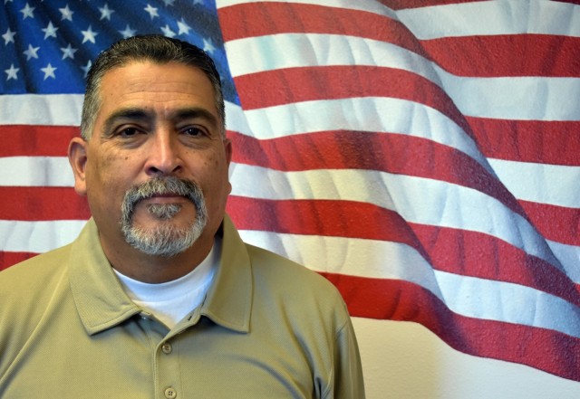 Oscar Ordonez, head of housing for U.S. Army Garrison Presidio of Monterey, poses for a photo in the conference room in the housing office, Ord Military Community, Calif. (Winifred Brown)