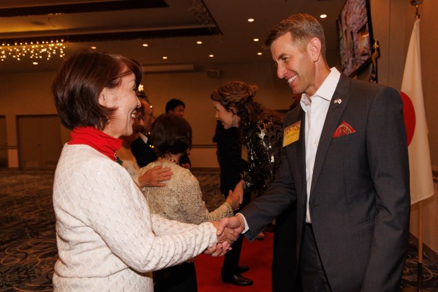 Col. Marcus Hunter, right, commander of U.S. Army Garrison Japan, greets guests during a holiday reception at Camp Zama, Japan, Dec. 16, 2024. More than 200 local community leaders and Camp Zama personnel attended the event to celebrate the...