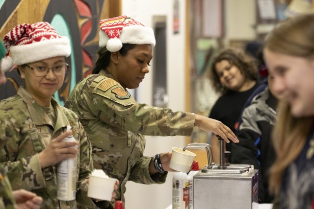 Alaska Air National Guard Master Sgt. Samantha Smith, assigned to the AKNG Joint Force Headquarters command support staff, serves ice cream to Yakutat children as part of Operation Santa Claus in Yakutat, Alaska, Dec. 18, 2024. Operation Santa...