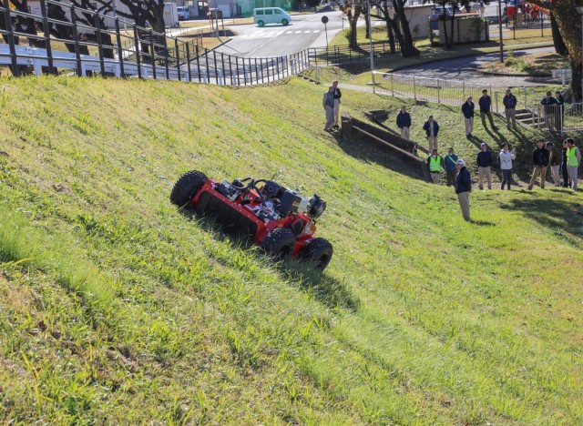 A vendor demonstrates a Sanyokiki remote-controlled lawnmower to Directorate of Public Works employees at Camp Zama, Japan, Dec. 6, 2024. DPW crews plan to use the mower to cut grass on the installation’s steep hills.
