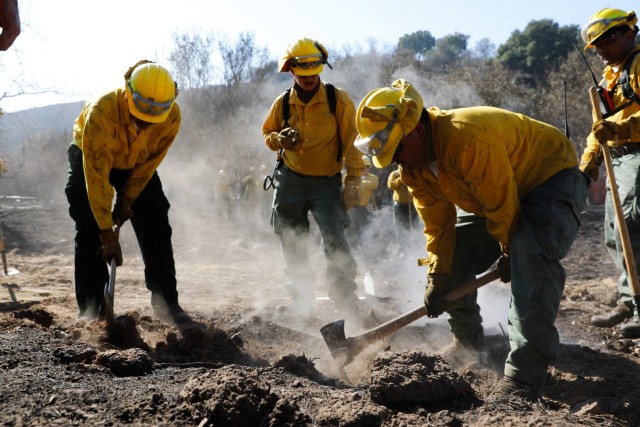 A California Army National Guard Fire Crew suppresses a hot spot caused by buried hot, smoldering debris at Palisades, Calif., Jan. 20, 2025. Handcrews, consisting of California Army National Guard soldiers trained by CAL FIRE, are tasked with...