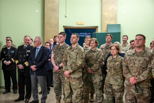 U.S. and Latvian service members listen as speakers address the audience during the opening of a new exhibit commemorating 32 years of U.S.-Latvian military partnership at the Latvian War Museum in Riga, Latvia, April 11, 2025. The exhibit, titled...