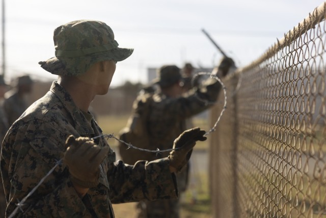 U.S. Marines install concertina wire on Naval Station Guantanamo Bay, Cuba Feb. 10, 2025. U.S. Southern Command is supporting illegal alien holding operations led by the Department of Homeland Security. (U.S. Marine Corps photo by Lance Cpl....