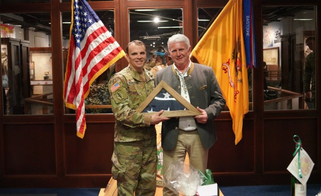 The garrison commander Col. Stephen C. Flanagan presenting the national flag to Zeilmann as a sign of recognition for his many years of support and dedication.