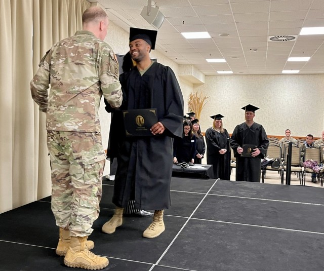 Brig. Gen. Daniel Cederman, Deputy Commanding General, Southern European Task Force Africa congratulates Darius Hale, a chaplains assistant, on the completion of his bachelor's degree.