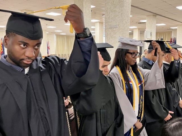 Graduates at the April 17 U.S. Army Garrison Italy. ceremony move their tassels to the left side, a time-honored tradition.