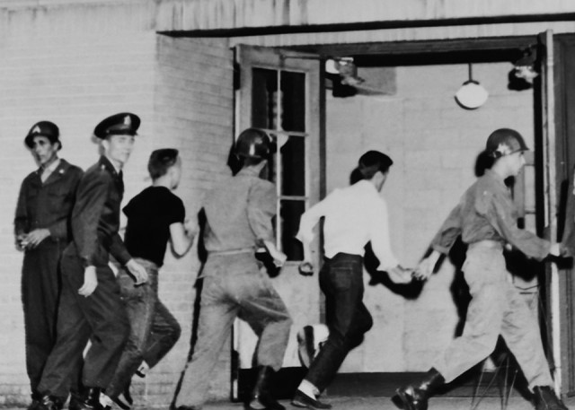 ATLANTA April 27, 1955 - Soldiers of the Georgia National Guard's 122nd Infantry Regiment, 179th Field Artillery Regiment, 48th Signal Company and 878th Engineer Aviation Battalion rush to the Atlanta armory during alert exercise Operation...