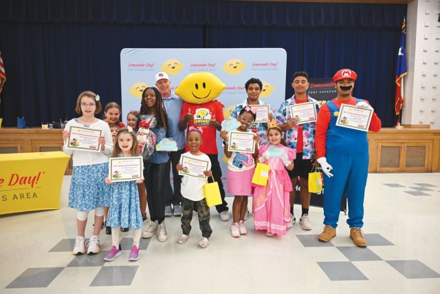 A group of people stand sit by side in two rows and pose for a picture.