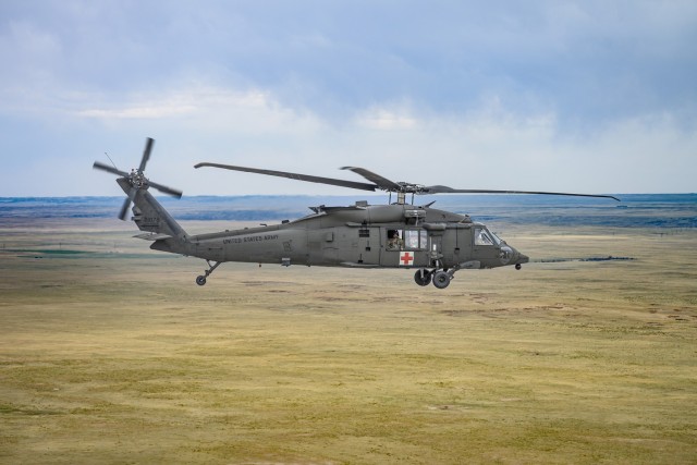 A HH-60M Black Hawk, assigned to Wyoming Army Aviation Support Facility, is airborne during an interagency bucket drop training at Camp Guernsey, Wyoming, on April 16, 2025. The training brought together Wyoming Aviation crews and partners...