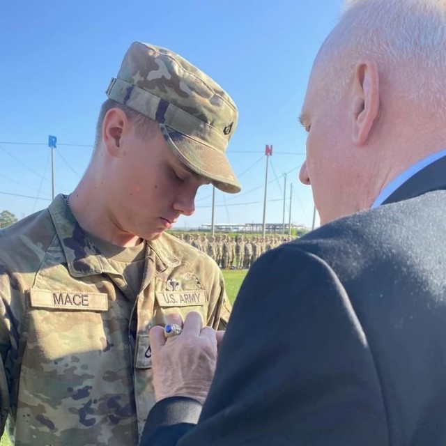 Lt. Cmdr. (ret.) Robert Mace pins airborne wings on his grandson, Pfc. Thor Mace, during Thor's airborne graduation at Fort Benning, GA in September 2024.