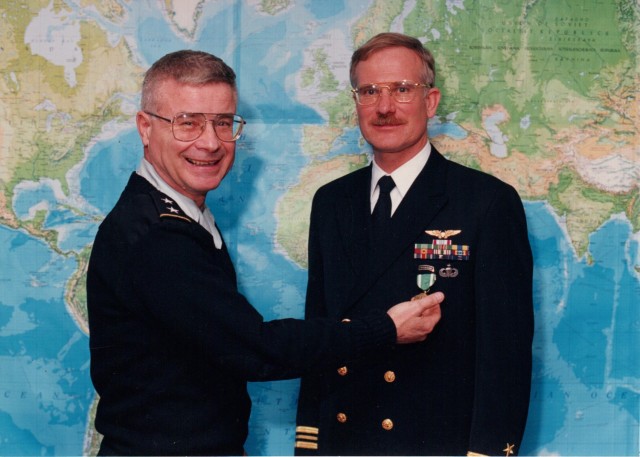 U.S. Navy Lt. Cmdr. Robert Mace (right), poses for a photo during an award ceremony in 1993.