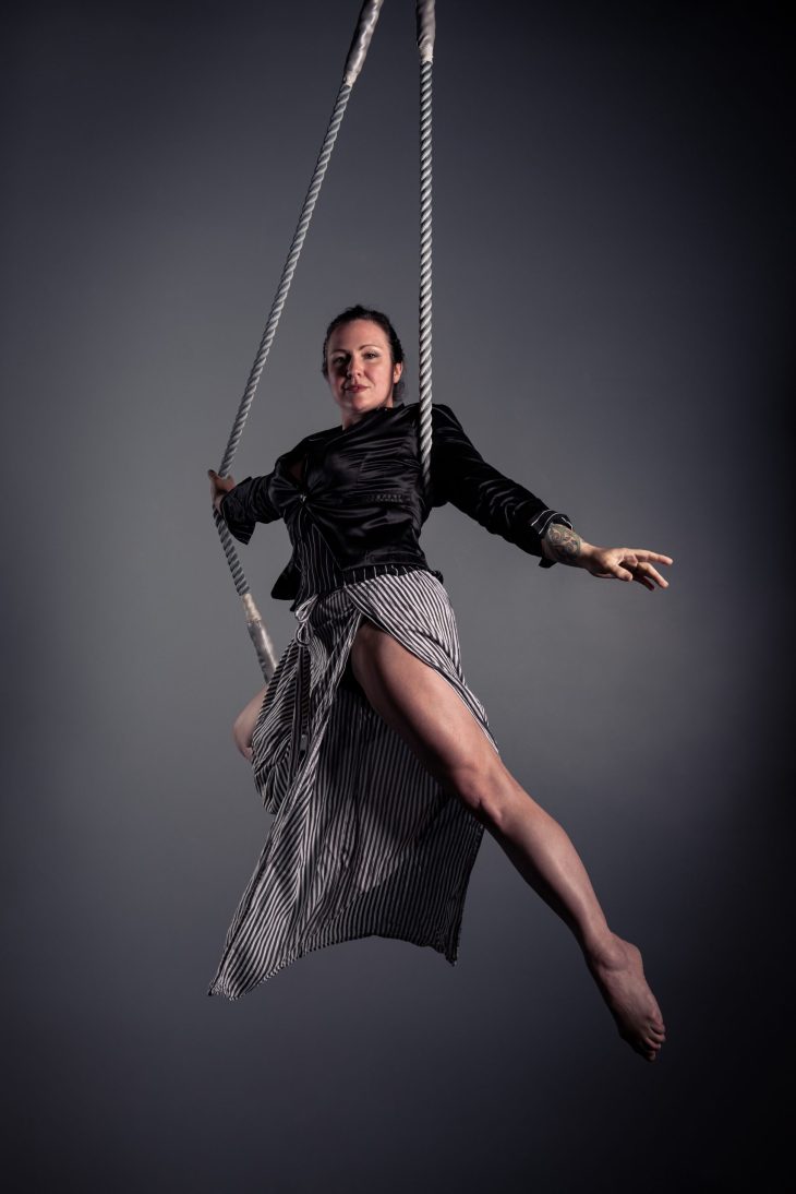 Woman hanging from rope.
