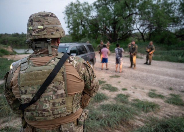 A U.S. Soldier with the Texas Army National Guard watches as U.S. Border Patrol agents conduct a traffic stop near the Rio Grande during a patrol near Roma, Texas, April 23, 2025. Texas Army Guard members are part of Operation Lone Star, working...