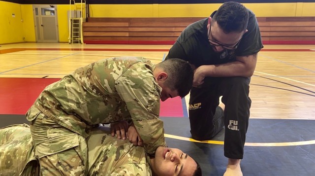 Staff Sgt. Christopher Burton oversees Soldiers conducting combatives training at the USAG Italy fitness center, May 16, 2025.