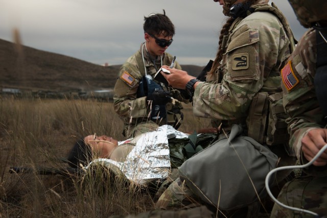 U.S. Army Spc. Julian Warner with Charlie Company, 181st Brigade Support Battalion, 81st Stryker Brigade Combat Team, Washington National Guard, administers aid to a patient during mass casualty training at Yakima Training Center, Wash., July 20,...