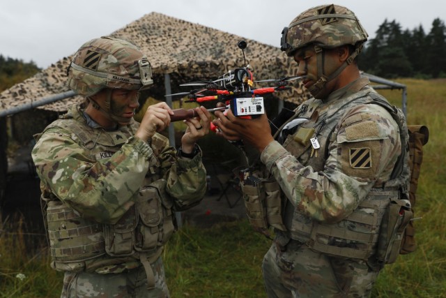 U.S. Army Sgt. Elena Killough and Sgt. Demond Blach, assigned to the Deathwatch Platoon, 10th Brigade Engineer Battalion, 1st Armored Brigade Combat Team, 3rd Infantry Division, conduct maintenance on an Unmanned Aircraft System during a first...