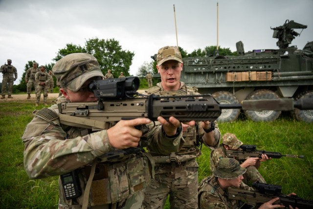 U.S. Army Capt. David Smith, the “Lightning Troop” company commander of 3rd Squadron, 2nd Cavalry Regiment, tests the SMASH X4 attached to a British Armed Forces SA80A3 rifle during Project Flytrap at Joint Multinational Readiness Center,...