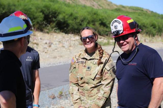 Lt. Col. Rebeccah Martinazzi, Operations Officer, 96th Aviation Troop Command talks with members of the Central and South Pierce Fire and Rescue during water bucket training with Central Pierce Fire and Rescue, June 30, 2025, near Puyallup, Wash....