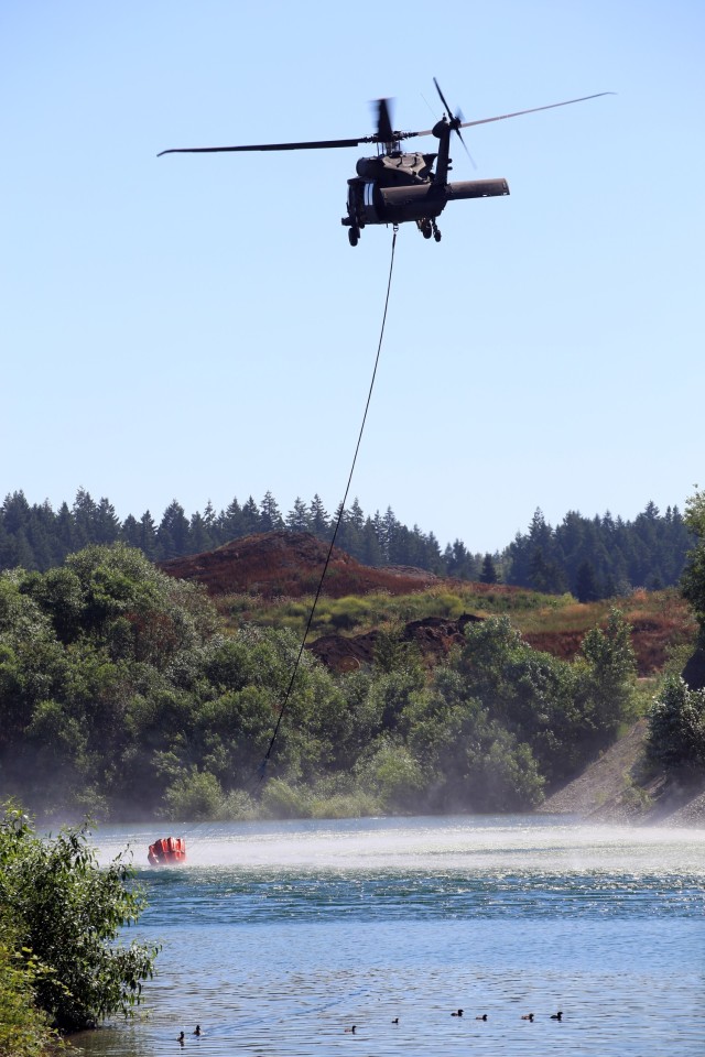 A UH-60 Blackhawk Helicopter from Charlie Company, 1st Battalion, 140th Aviation, 96th Troop Command, Washington Army National Guard conducts water bucket training with Central Pierce Fire and Rescue, June 30, 2025, near Puyallup, Wash. (U.S....
